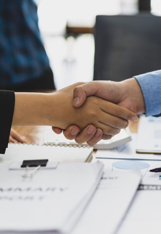 Business partners shaking hands at a strategic meeting