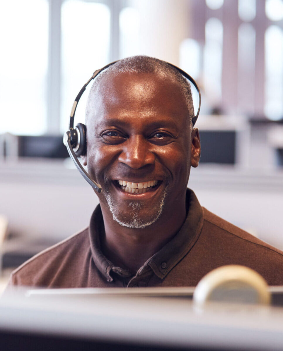 Mature IT consultant and support engineer wearing headset